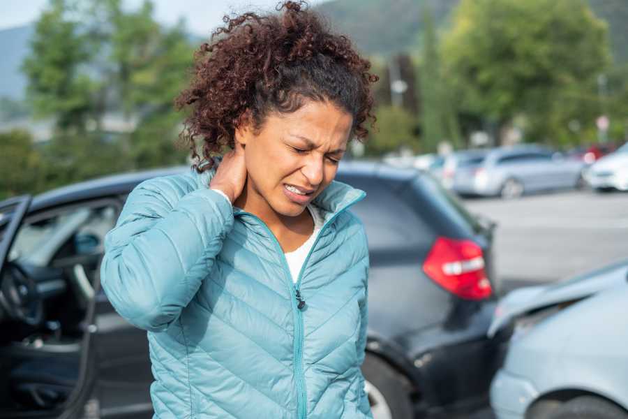 Woman feeling neck ache after bad cars pile up